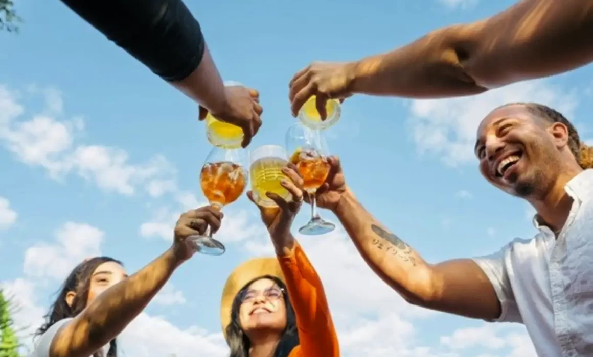 Image of people enjoying beverages with precision tunnel pasteurizer preserving premium beverage flavor